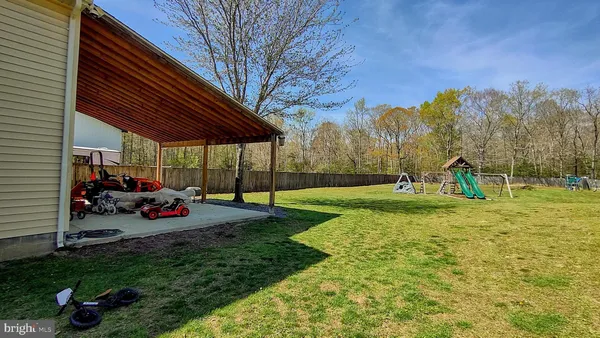 a kitchen with a sink cabinets and wooden floor