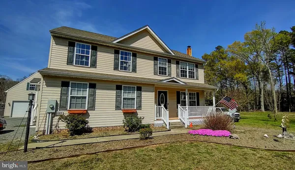 a kitchen with refrigerator and chairs