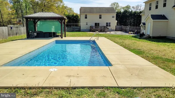 a dining room with furniture a chandelier and window