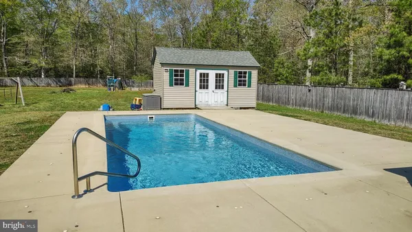 a dining room with furniture and a chandelier