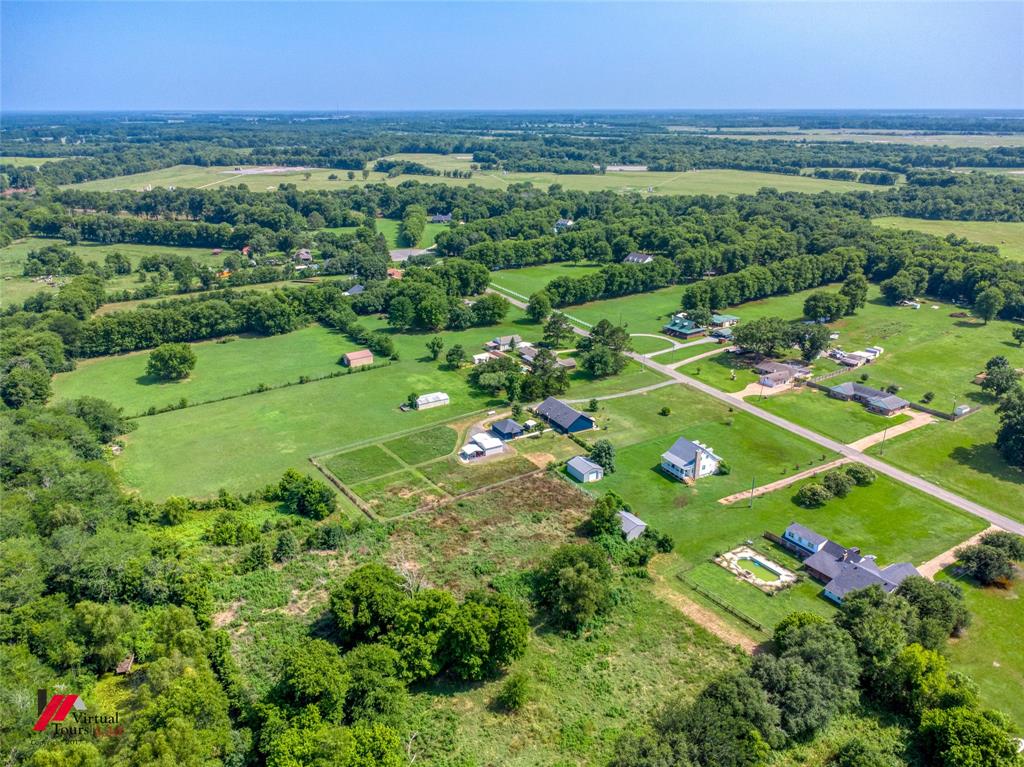 179 Ranchtown Road Elm Grove, LA 71051 - Photo 21 of 26 Expansive agricultural landscape featuring multiple residential structures, barns, and outbuildings