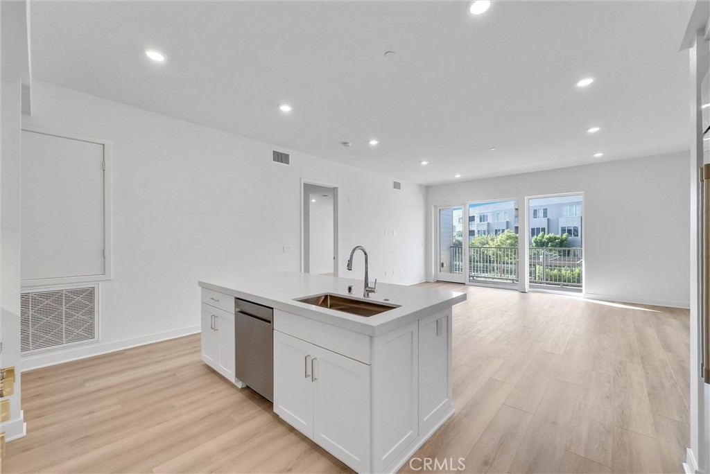 4302 Rivington Irvine, CA 92612 - Photo 15 of 62 a kitchen with kitchen island granite countertop a stove and a sink