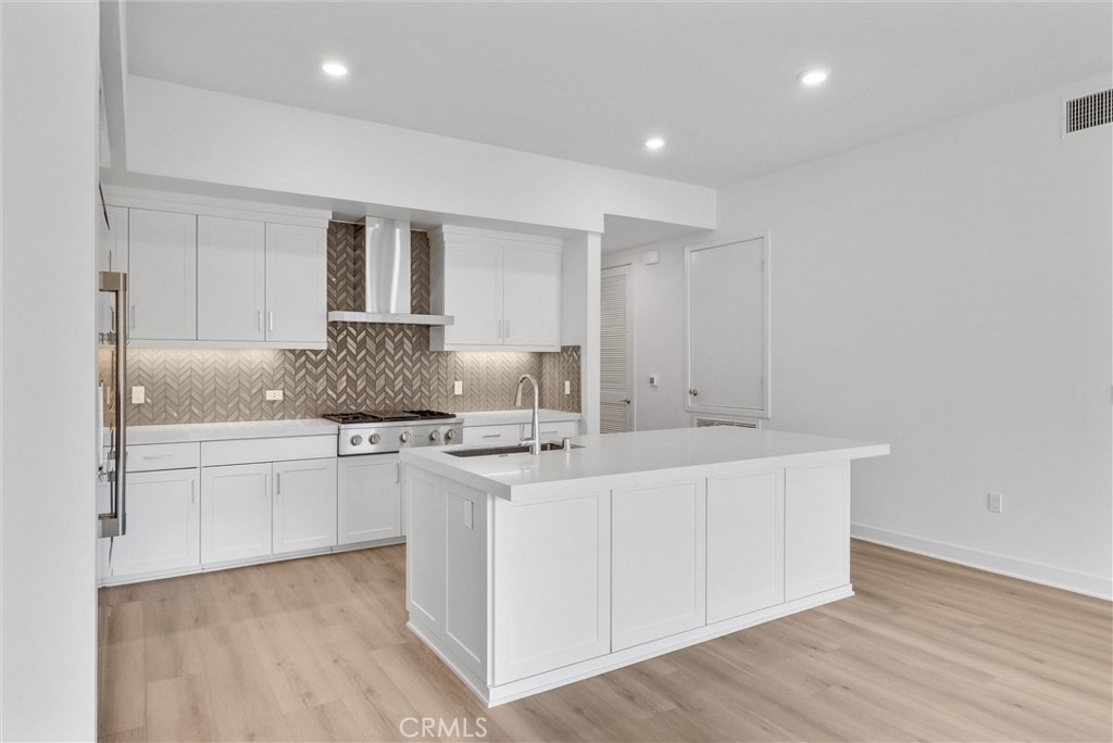 4302 Rivington Irvine, CA 92612 - Photo 16 of 62 a kitchen with stainless steel appliances granite countertop a sink and cabinets