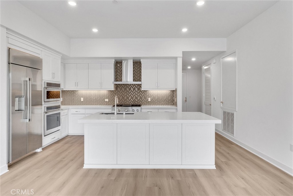 4302 Rivington Irvine, CA 92612 - Photo 17 of 62 a living room with stainless steel appliances furniture a refrigerator and wooden floor