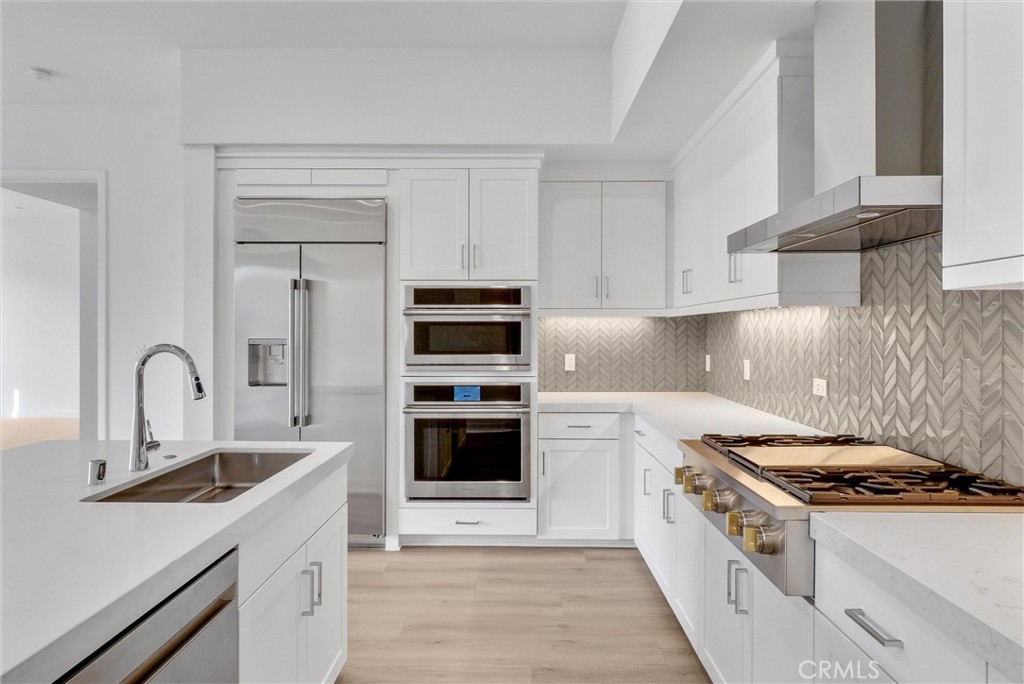 4302 Rivington Irvine, CA 92612 - Photo 19 of 62 a kitchen with white cabinets and appliances