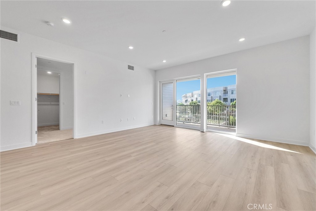 4302 Rivington Irvine, CA 92612 - Photo 21 of 62 a view of an empty room with wooden floor and a window