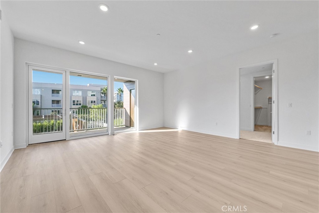 4302 Rivington Irvine, CA 92612 - Photo 23 of 62 a view of an empty room with wooden floor and a sliding door