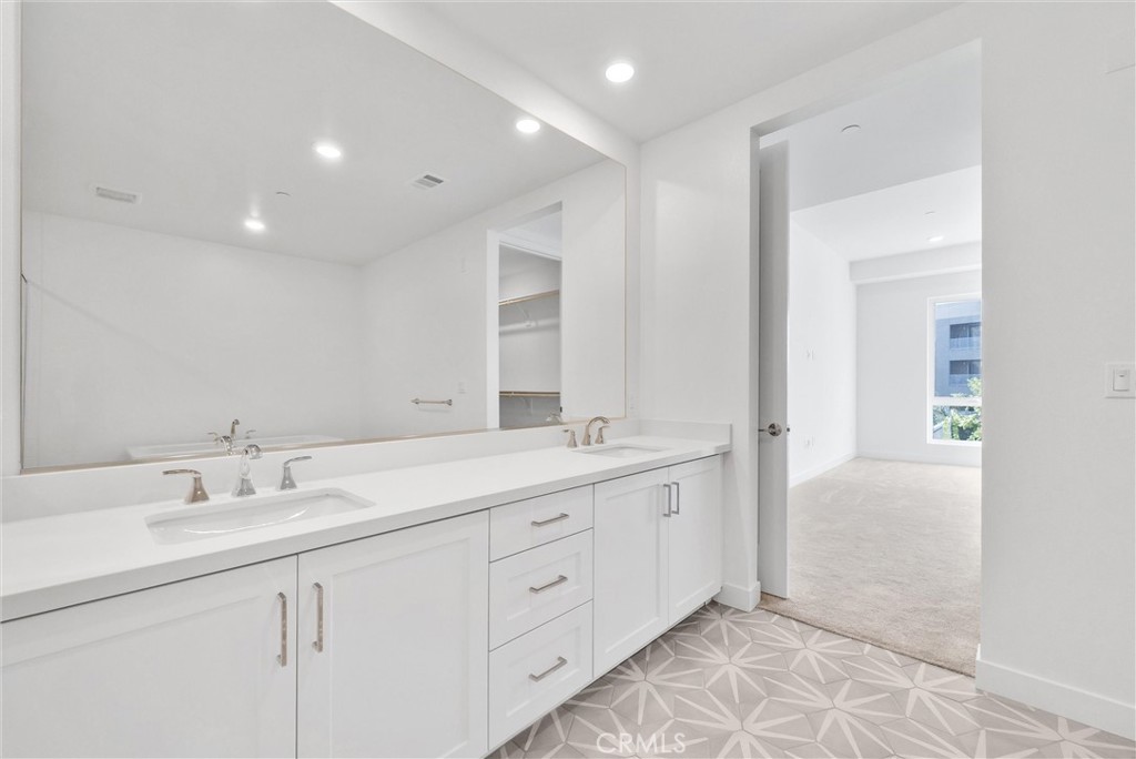 4302 Rivington Irvine, CA 92612 - Photo 42 of 62 a spacious bathroom with a double vanity sink and a mirror