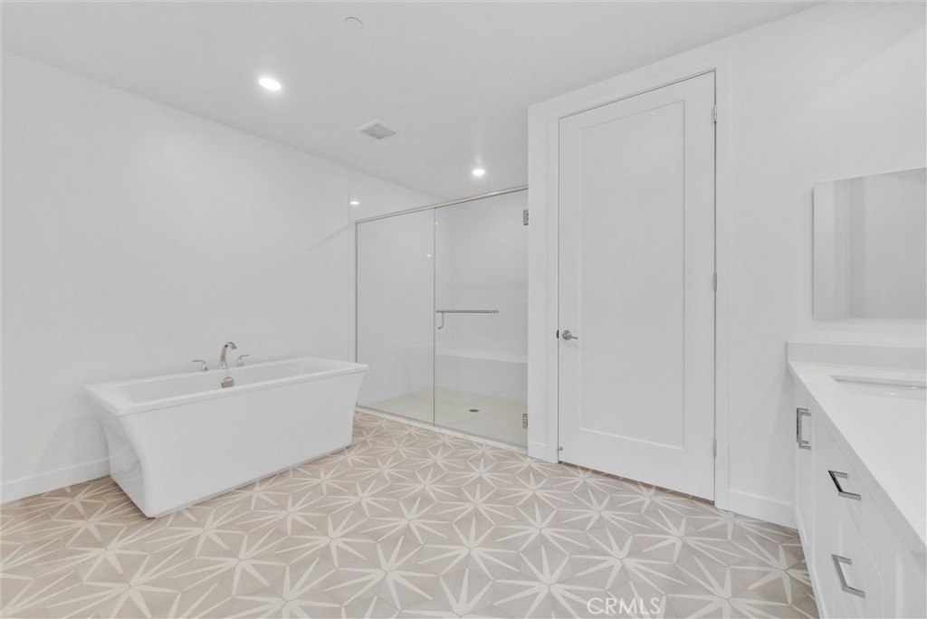 4302 Rivington Irvine, CA 92612 - Photo 43 of 62 a bathroom with a bathtub sink and mirror