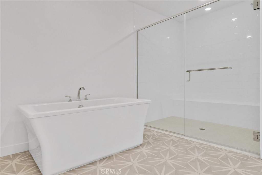 4302 Rivington Irvine, CA 92612 - Photo 44 of 62 a bathroom with a bathtub and shower