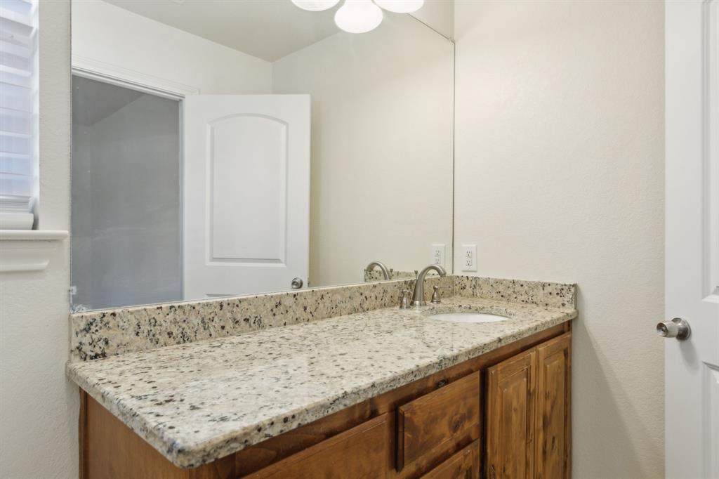 233 Firefly Drive Springtown, TX 76082 - Photo 9 of 16 Primary bathroom featuring a vanity with a granite countertop