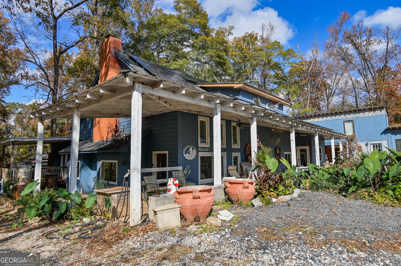 11725 Hazelbrand Road Northeast Covington, GA 30014 - Photo 16 of 71 a view of a brick house with large windows and plants