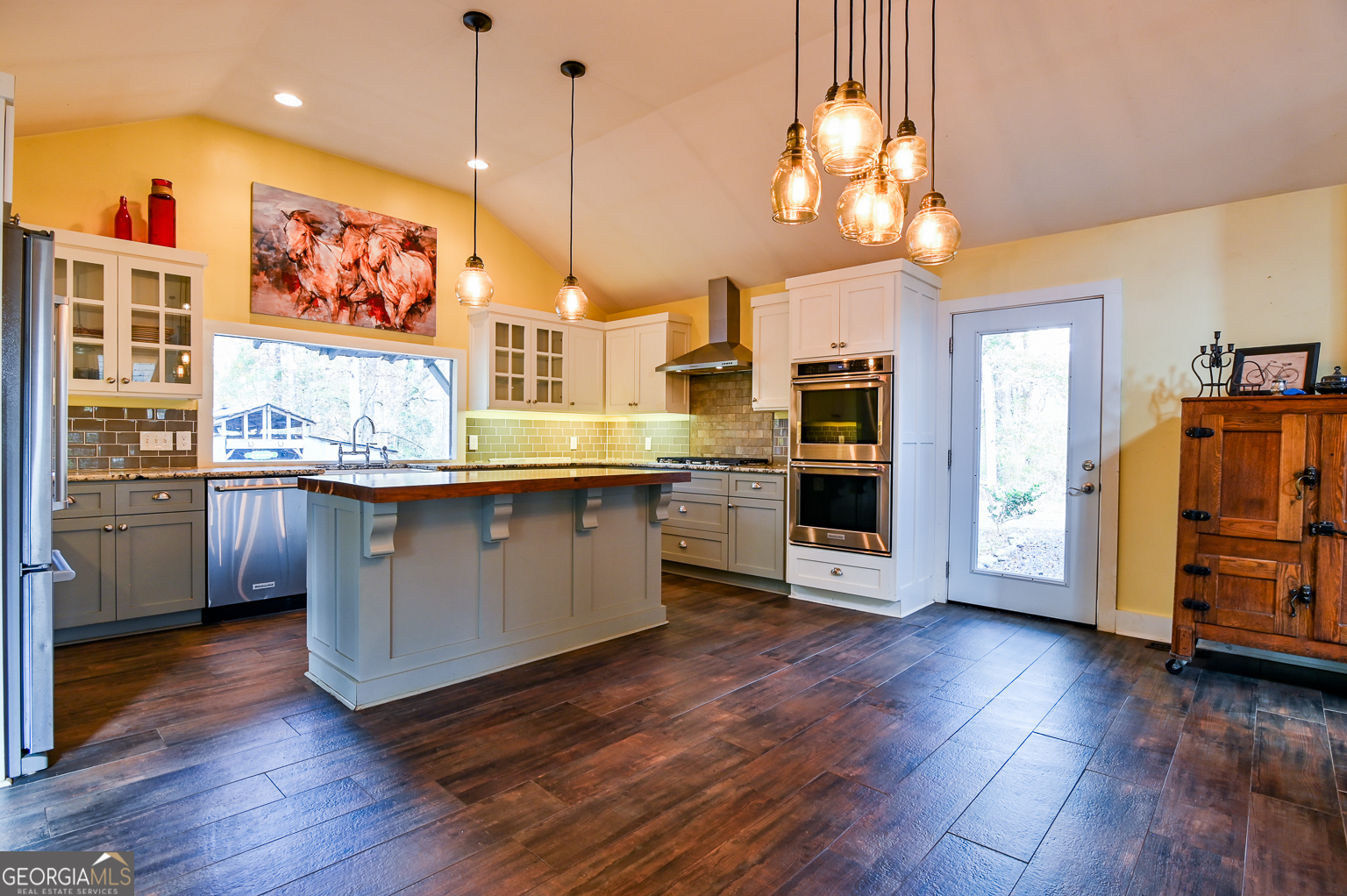 11725 Hazelbrand Road Northeast Covington, GA 30014 - Photo 27 of 71 a kitchen with stainless steel appliances granite countertop a refrigerator a sink dishwasher a stove and a dining table with wooden floor