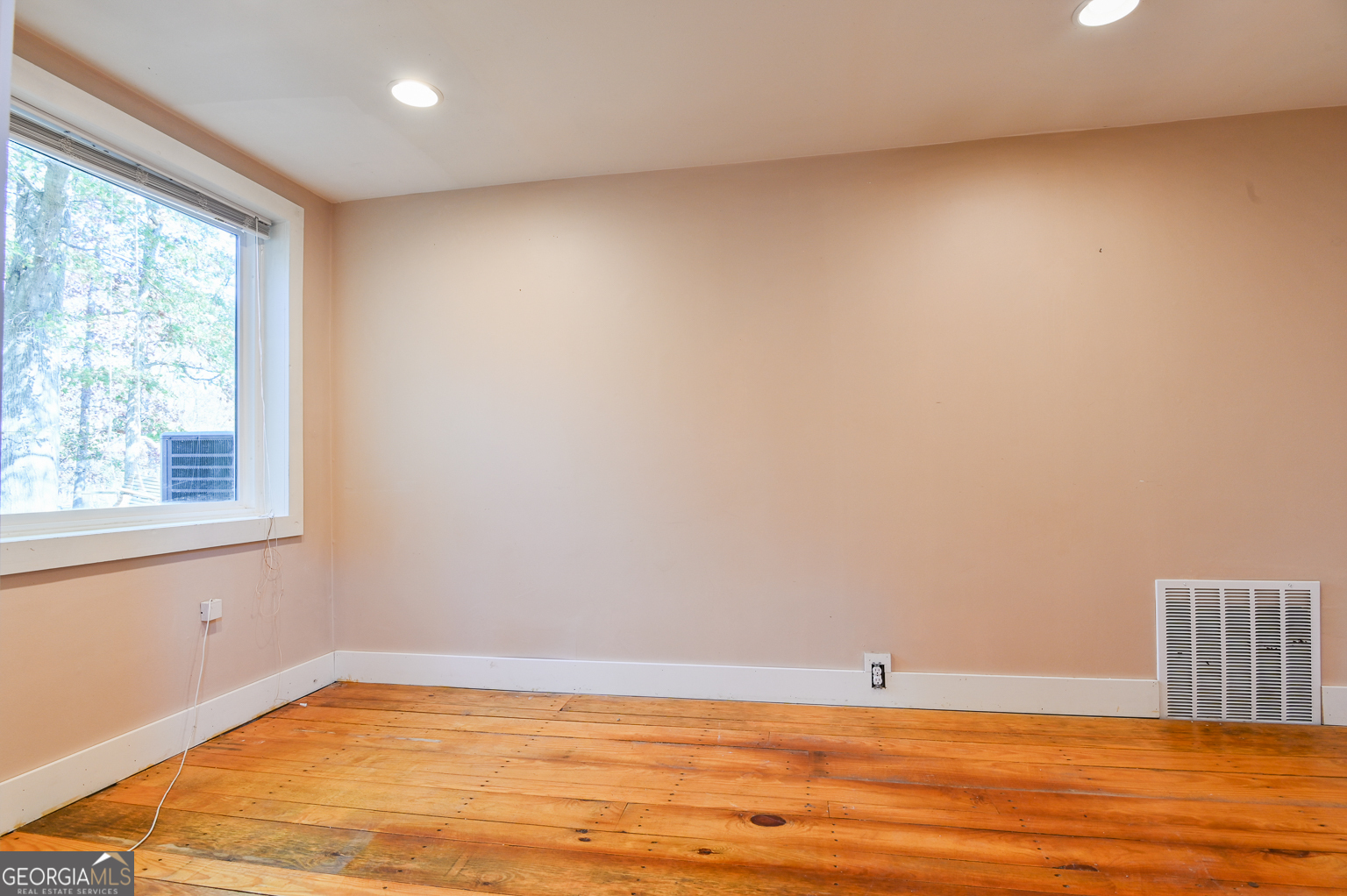 11725 Hazelbrand Road Northeast Covington, GA 30014 - Photo 33 of 71 a view of empty room with wooden floor and fan