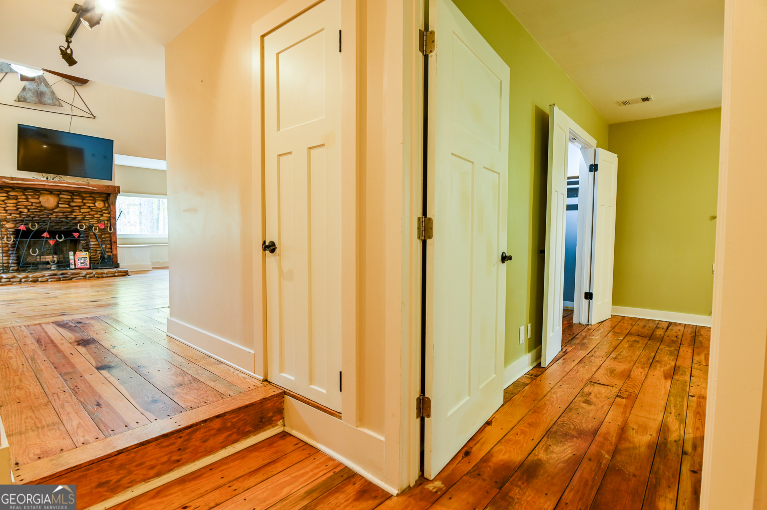 11725 Hazelbrand Road Northeast Covington, GA 30014 - Photo 34 of 71 a view of a hallway with wooden floor and staircase