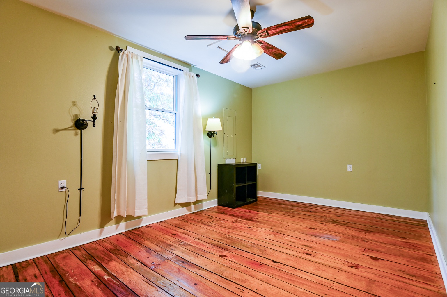 11725 Hazelbrand Road Northeast Covington, GA 30014 - Photo 35 of 71 a bedroom with a bed and a chandelier