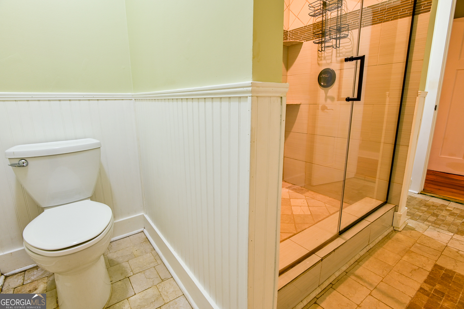 11725 Hazelbrand Road Northeast Covington, GA 30014 - Photo 38 of 71 a white toilet sitting next to a shower curtain
