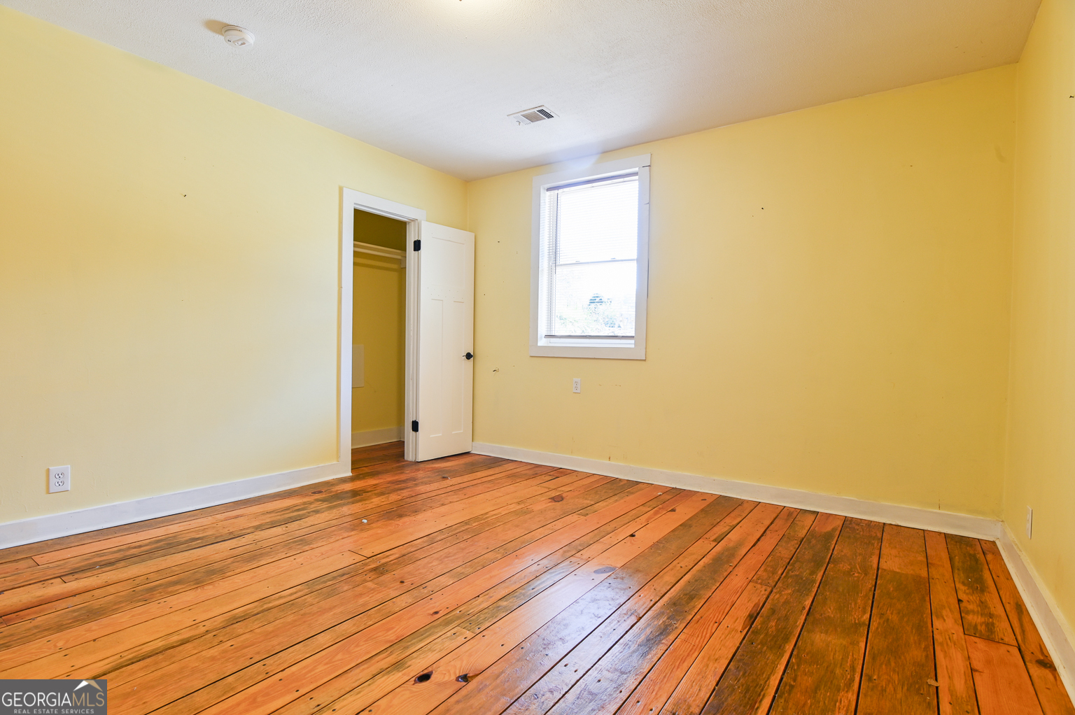 11725 Hazelbrand Road Northeast Covington, GA 30014 - Photo 41 of 71 a view of an empty room with wooden floor and a window