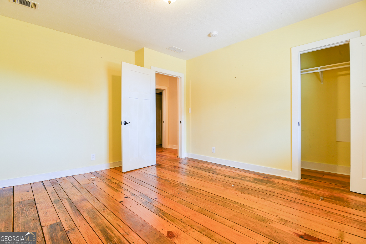 11725 Hazelbrand Road Northeast Covington, GA 30014 - Photo 42 of 71 a view of an empty room with wooden floor