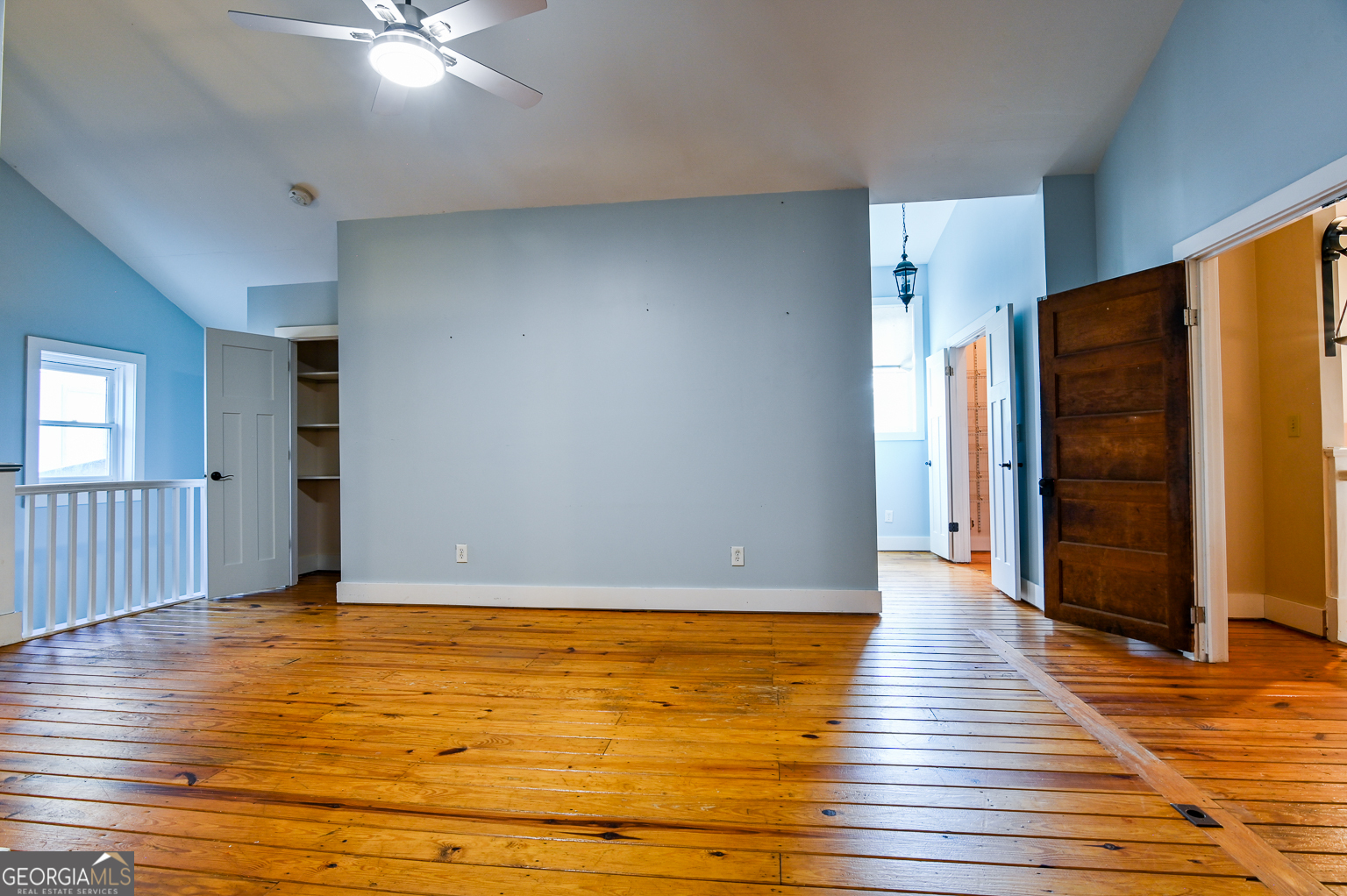 11725 Hazelbrand Road Northeast Covington, GA 30014 - Photo 55 of 71 an empty room with wooden floor closet and windows