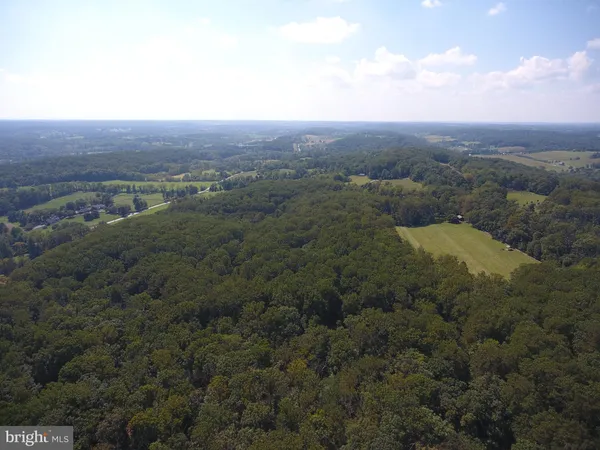 an aerial view of residential house and green space