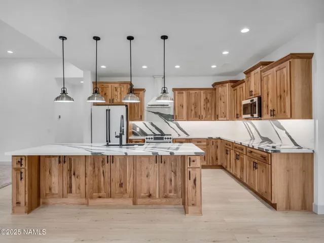 a kitchen with a refrigerator and a sink