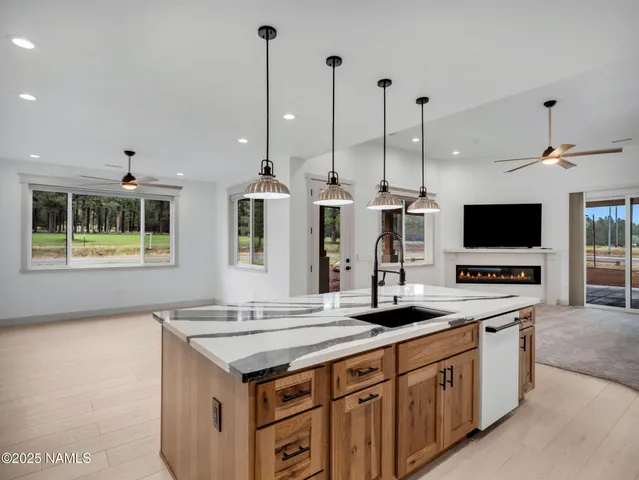 a living room with a flat screen tv and a fireplace