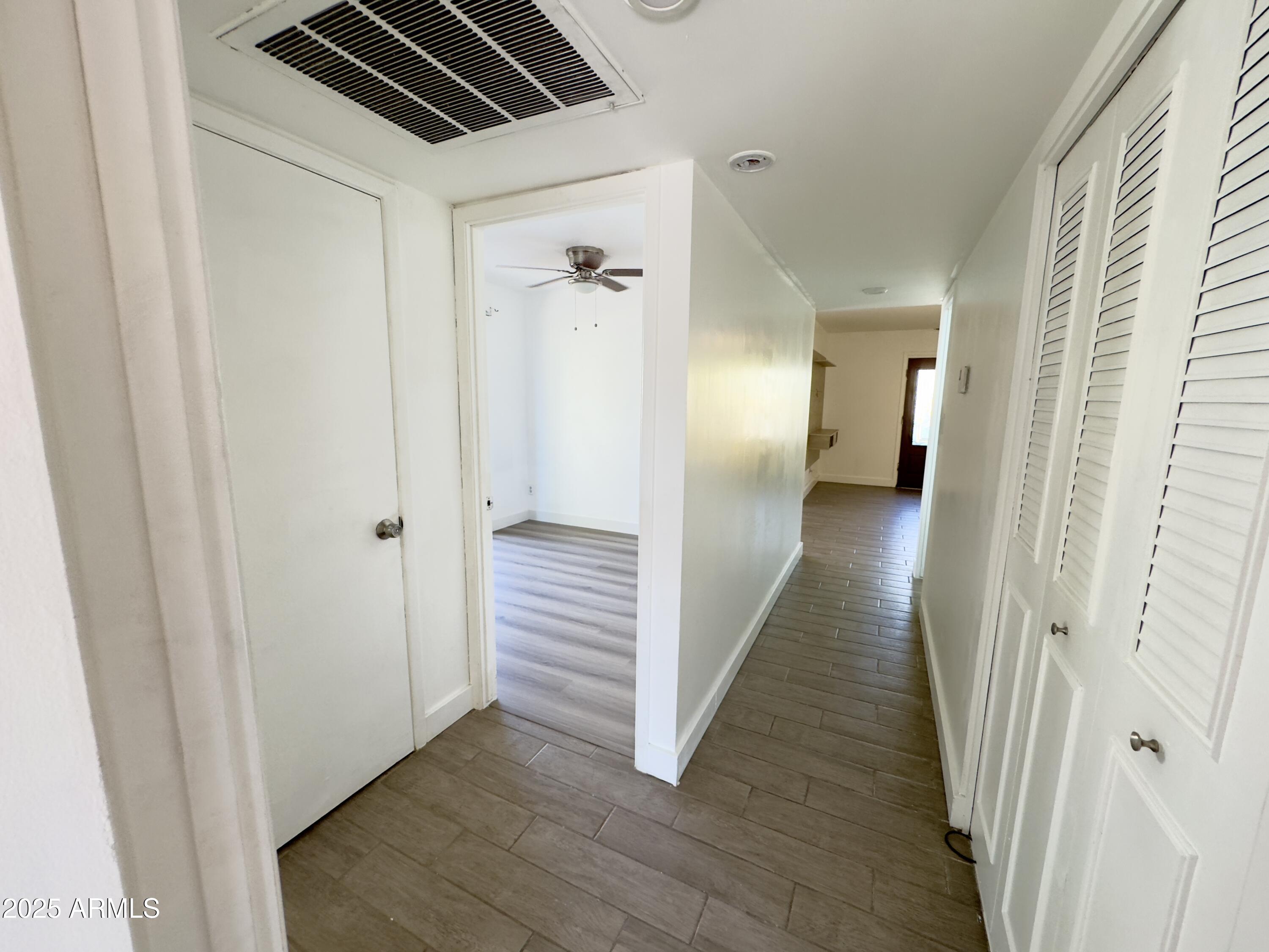 1021 West Mission Lane Phoenix, AZ 85021 - Photo 11 of 20 a view of a hallway with wooden floor