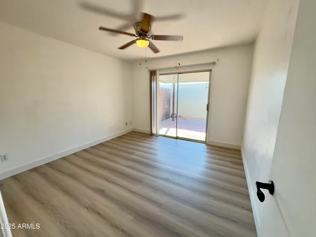a view of a room with wooden floor and staircase