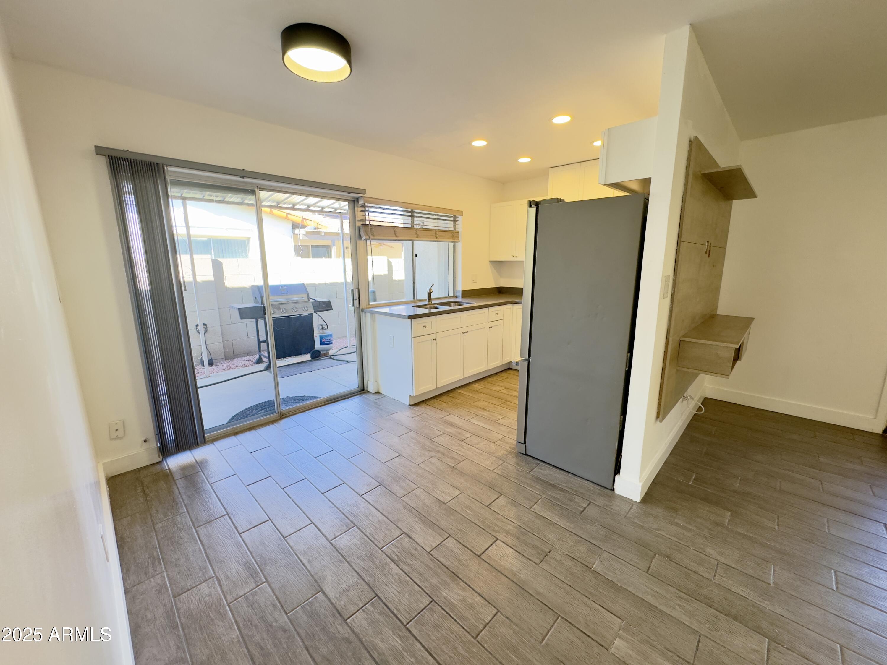 1021 West Mission Lane Phoenix, AZ 85021 - Photo 4 of 20 a view of a kitchen with a sink and a refrigerator