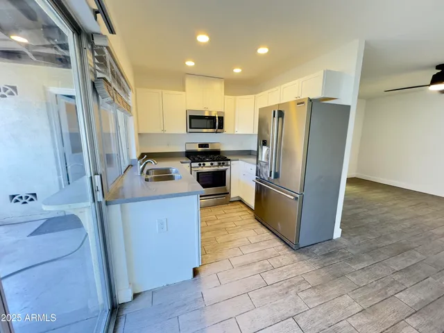 a kitchen with sink and large window