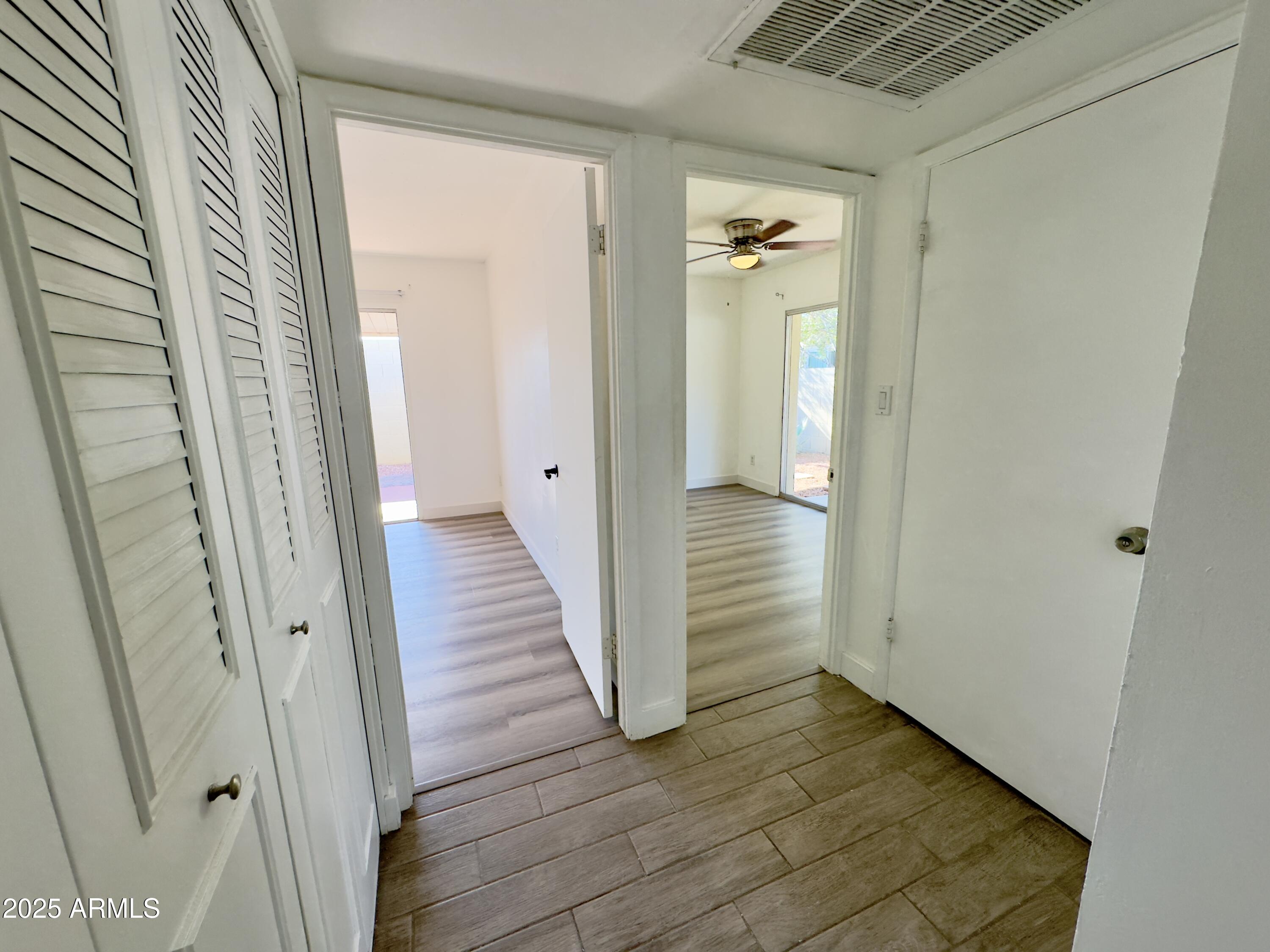 1021 West Mission Lane Phoenix, AZ 85021 - Photo 8 of 20 a view of a hallway with wooden floor and closet area
