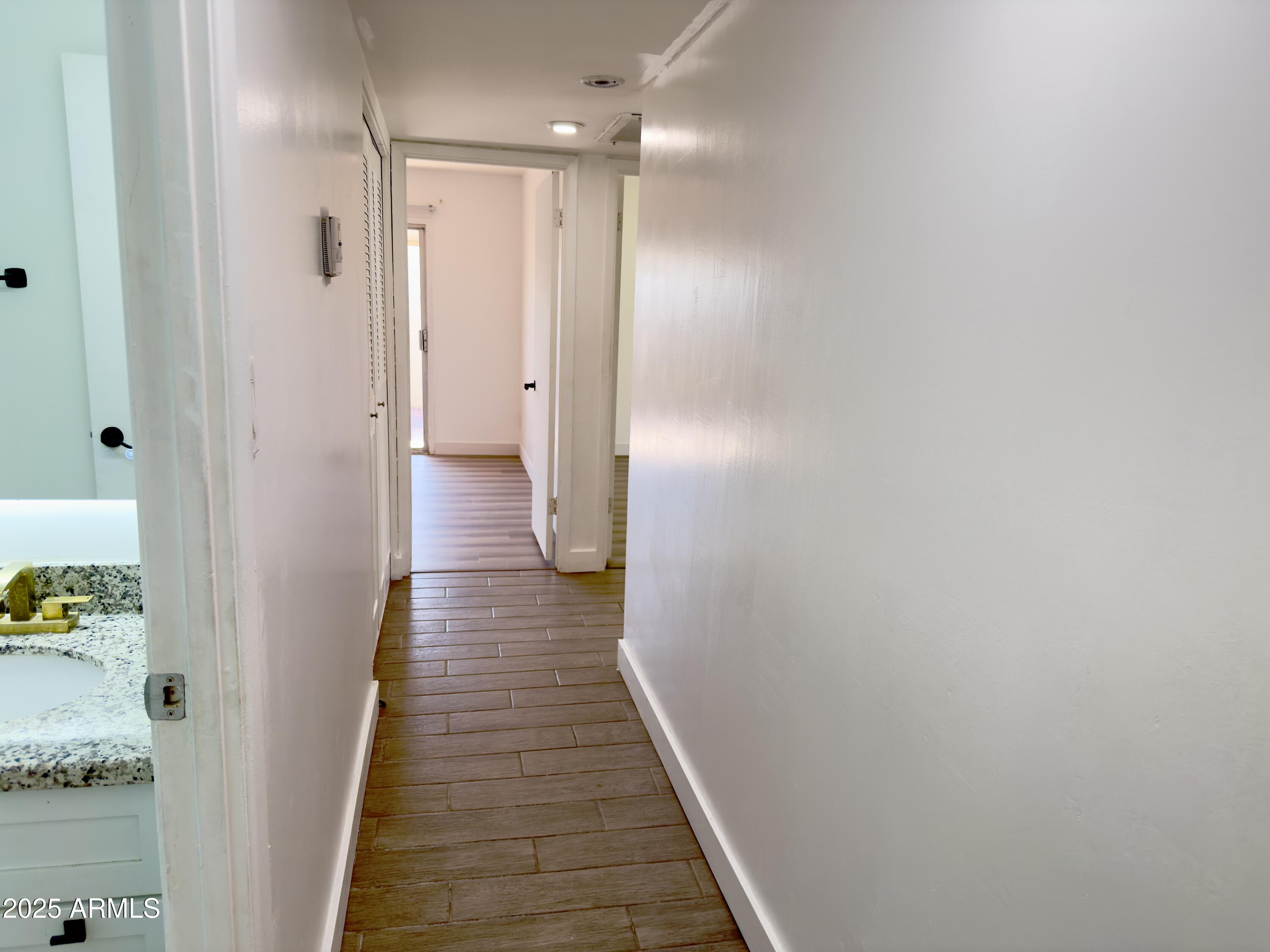 1021 West Mission Lane Phoenix, AZ 85021 - Photo 9 of 20 a view of a hallway with wooden floor