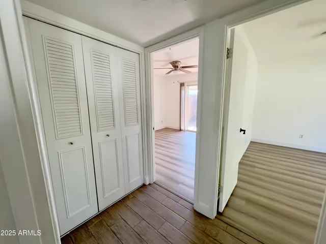 a view of a hallway with wooden floor