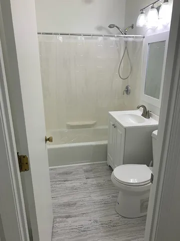 a bathroom with a toilet and a shower