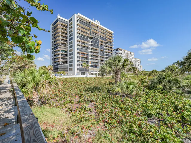 a living room with furniture a flat screen tv and a window
