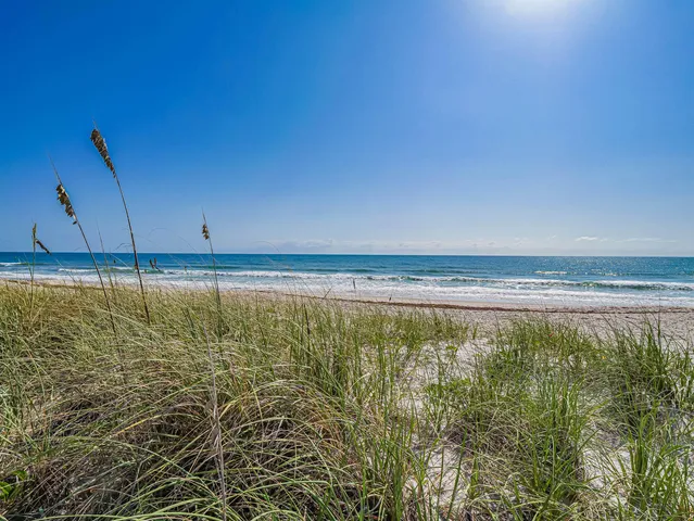 a kitchen with white cabinets sink and stainless steel appliances