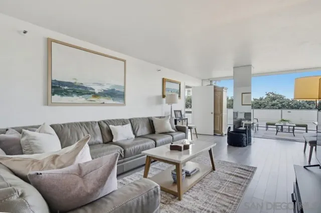 a living room with furniture and kitchen view