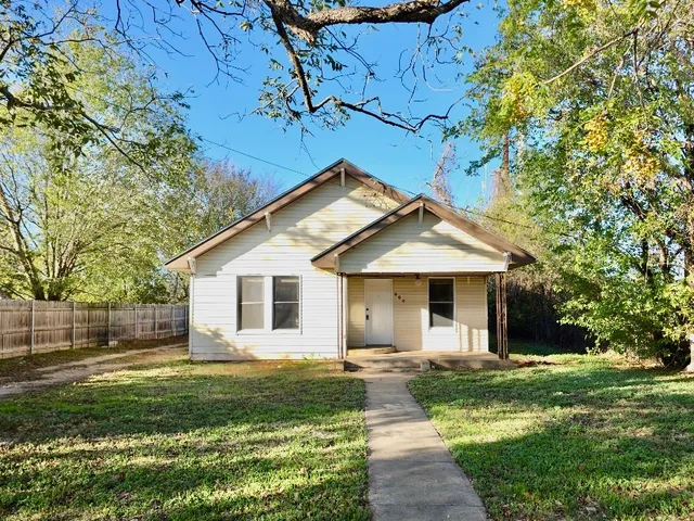 a front view of house with yard and green space