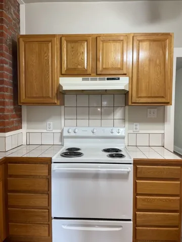 a kitchen with a stove and a cabinet