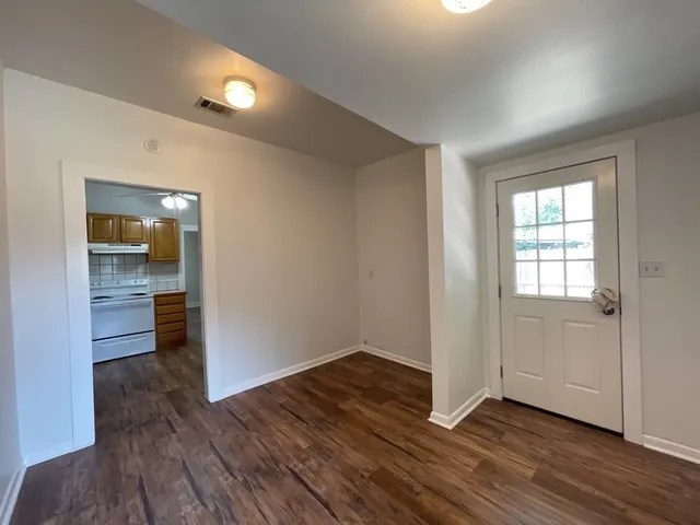 wooden floor in an empty room with a window