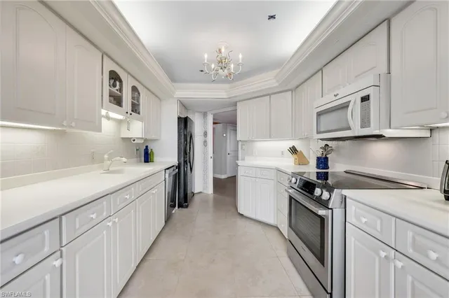 a kitchen with cabinets a sink and appliances