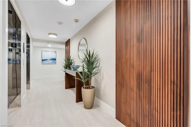 a view of a hallway with potted plants