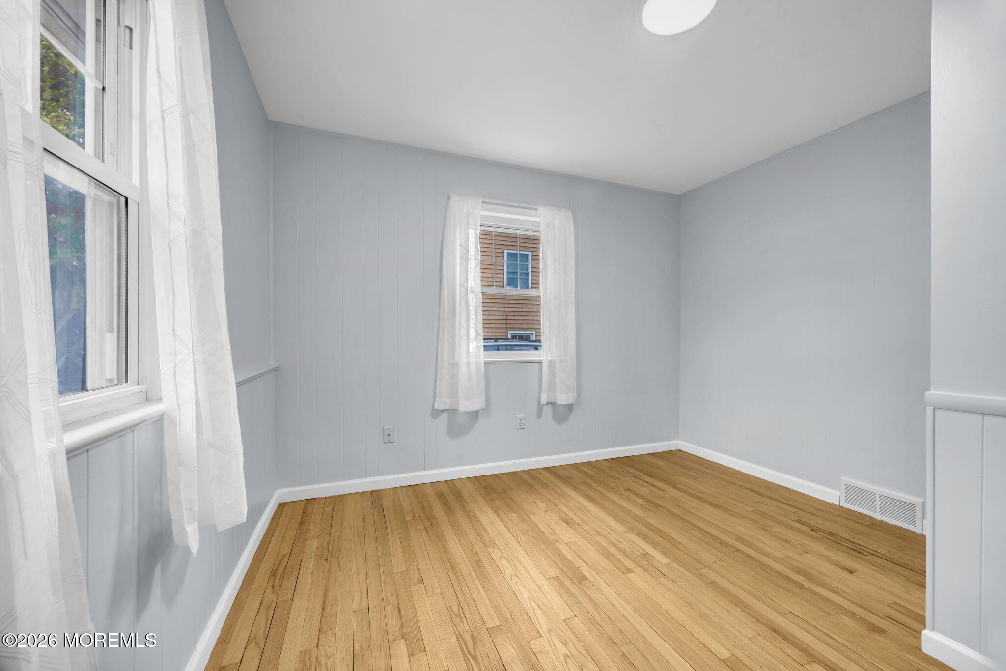 108 Susan Drive Ewing, NJ 08638 - Photo 14 of 40 a view of empty room with wooden floor and fan