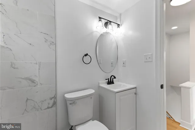 a bathroom with a toilet sink and mirror