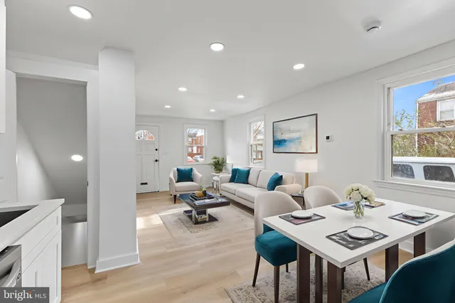 a living room with furniture a table and a potted plant