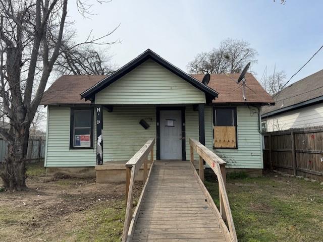 a front view of a house with a wooden fence