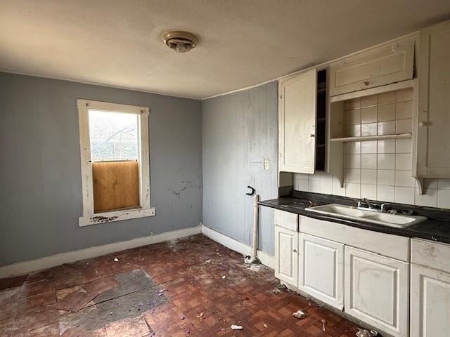 2204 R. W. Bivens Lane Fort Worth, TX 76105 - Photo 3 of 8 a kitchen with granite countertop a stove a sink and a microwave