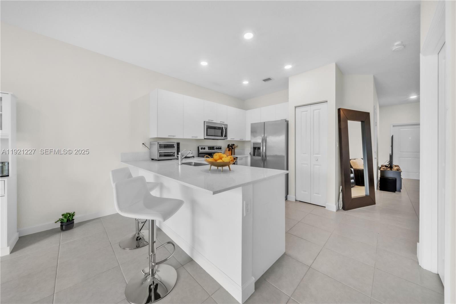 12917 Northwest 23rd Place Miami, FL 33147 - Photo 11 of 43 a kitchen with stainless steel appliances a refrigerator and a stove top oven