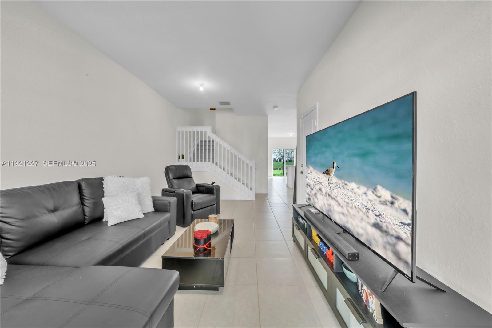 12917 Northwest 23rd Place Miami, FL 33147 - Photo 14 of 43 a living room with furniture and a flat screen tv
